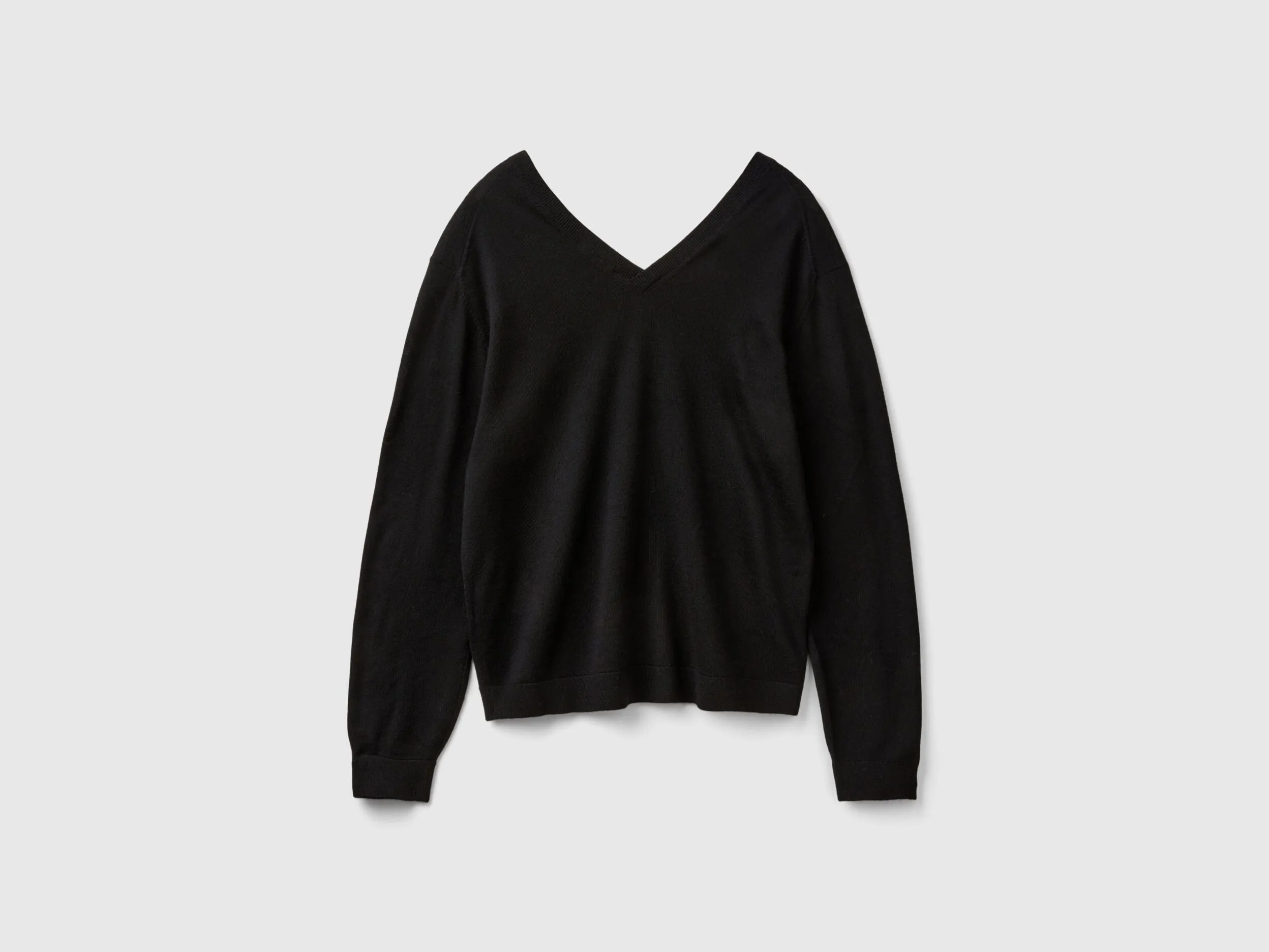 V-neck sweater in pure Merino wool - Black | Benetton